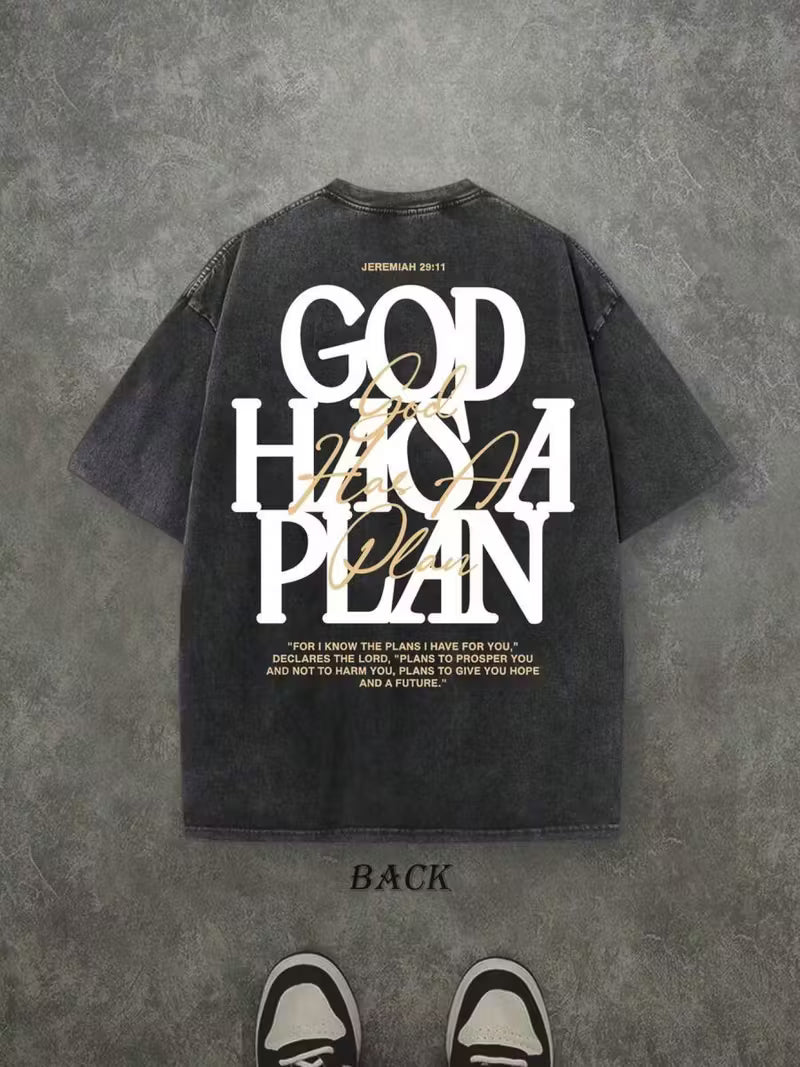 Black t-shirt with 'God has a plan' text on a gray textured background