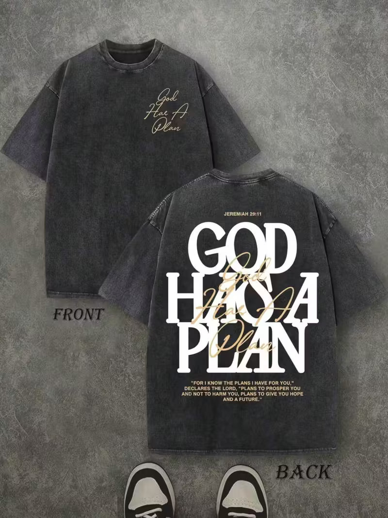 Black t-shirt with 'God Has A Plan' text on a gray background